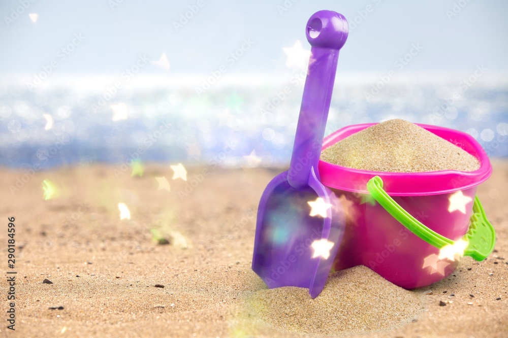 Shot of the beach on a sunny day, with a spade and bucket