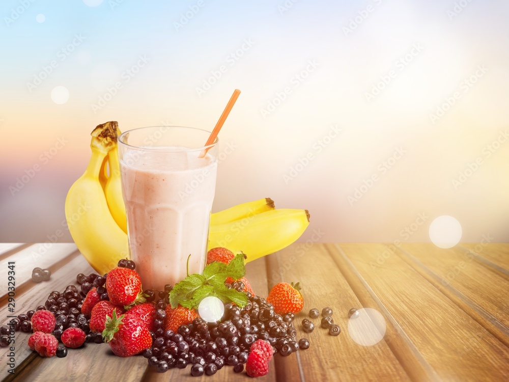 Healthy Fruit Smoothie in glass on wooden table Background