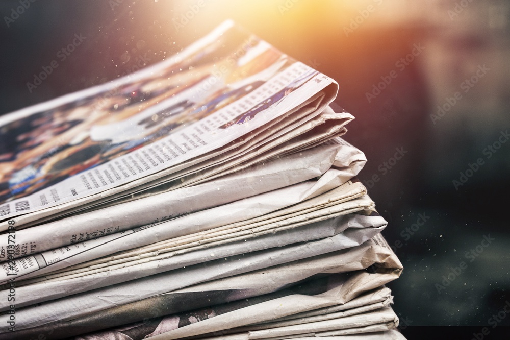 Pile of newspapers on white background