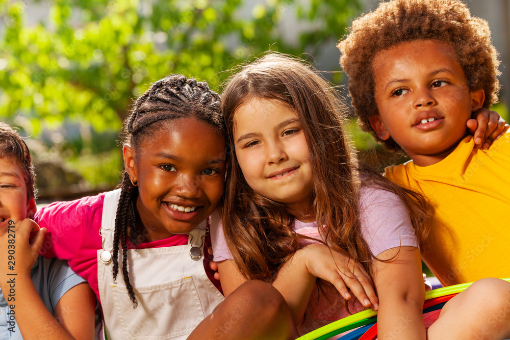 Close-up portrait of kids group hug and smiling