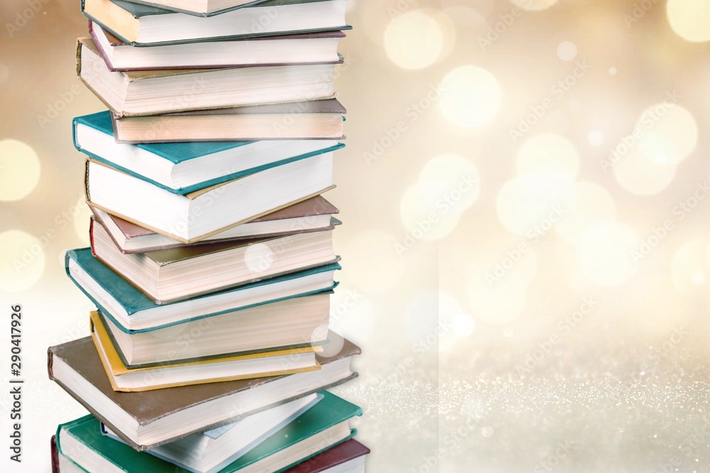 Stack of colorful books on  background