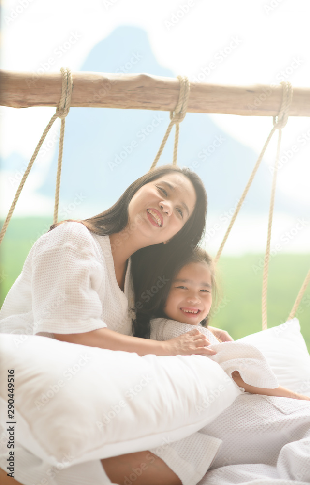  girl and her mother enjoy sunny morning. Good time at the nature background of the valley