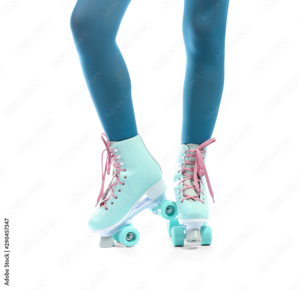 Legs of young woman on roller skates against white background