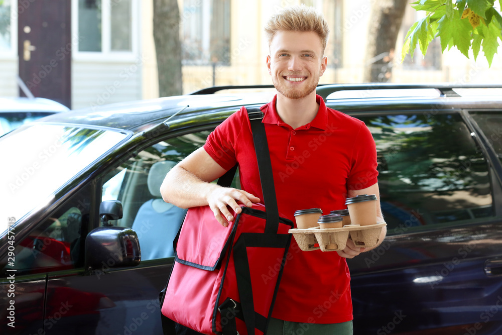 Worker of food delivery service near car outdoors