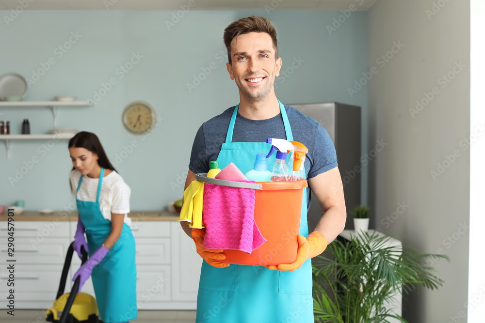 Young couple cleaning kitchen together