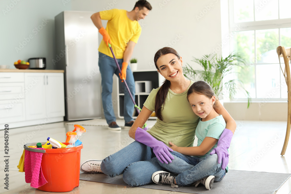 Happy family cleaning kitchen together