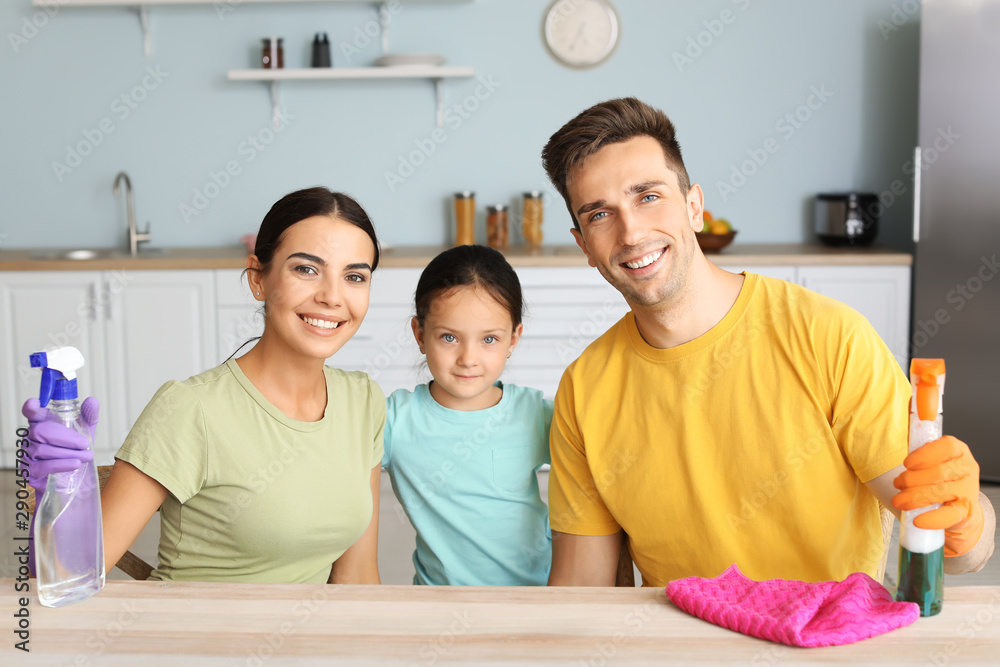 Happy family cleaning kitchen together