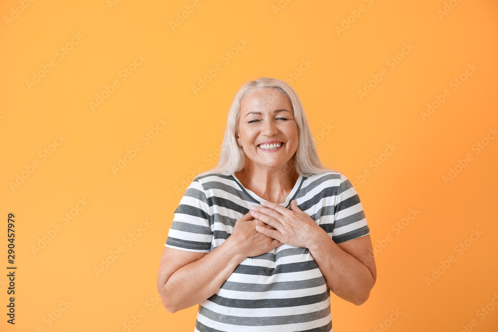 Happy mature woman on color background