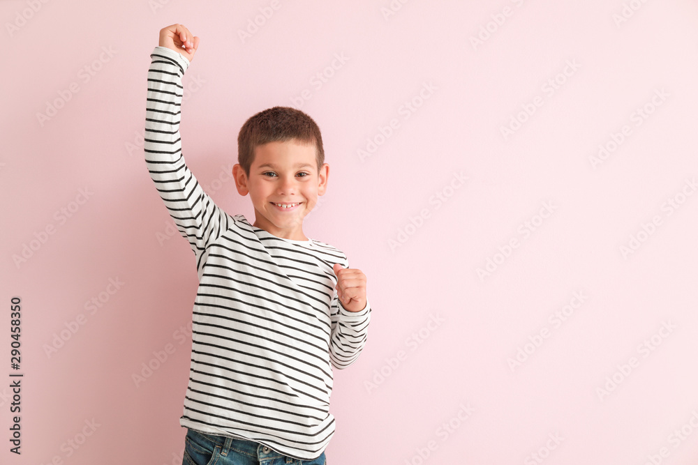 Portrait of happy little boy on color background