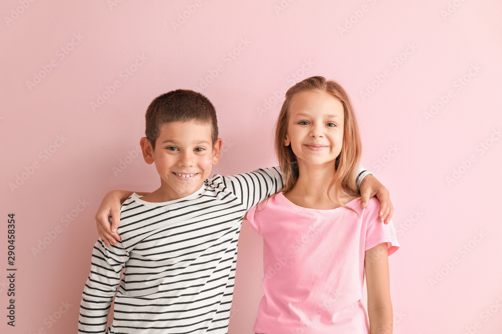 Portrait of happy little children on color background