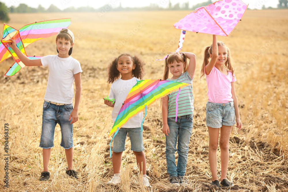 Little children flying kites outdoors