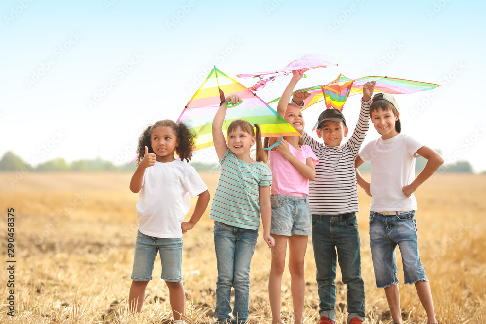 Little children flying kites outdoors