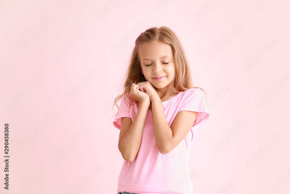 Portrait of happy little girl on color background