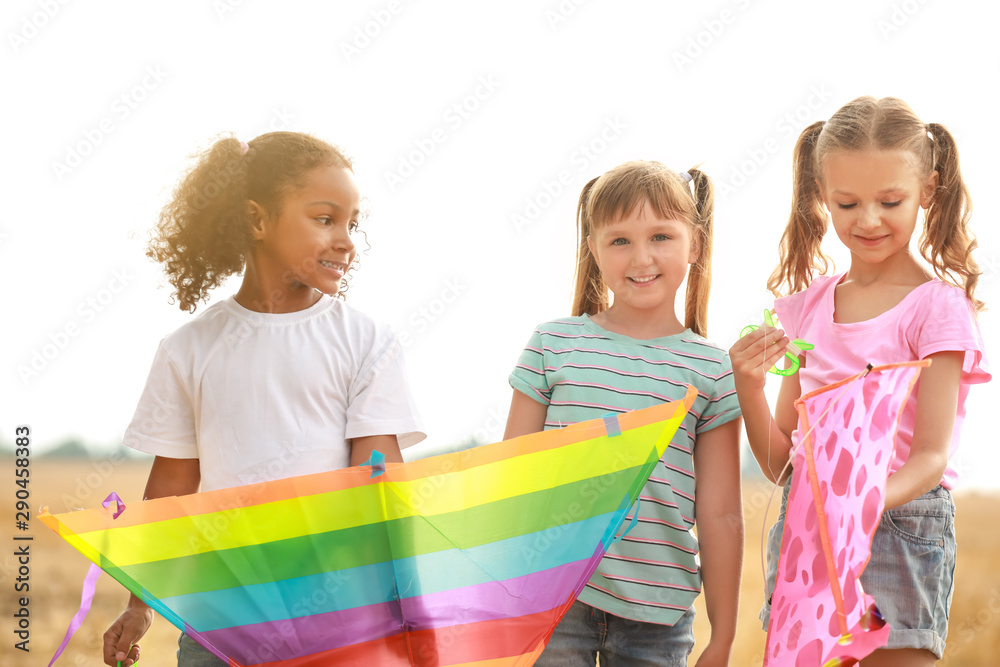 Little girls flying kites outdoors