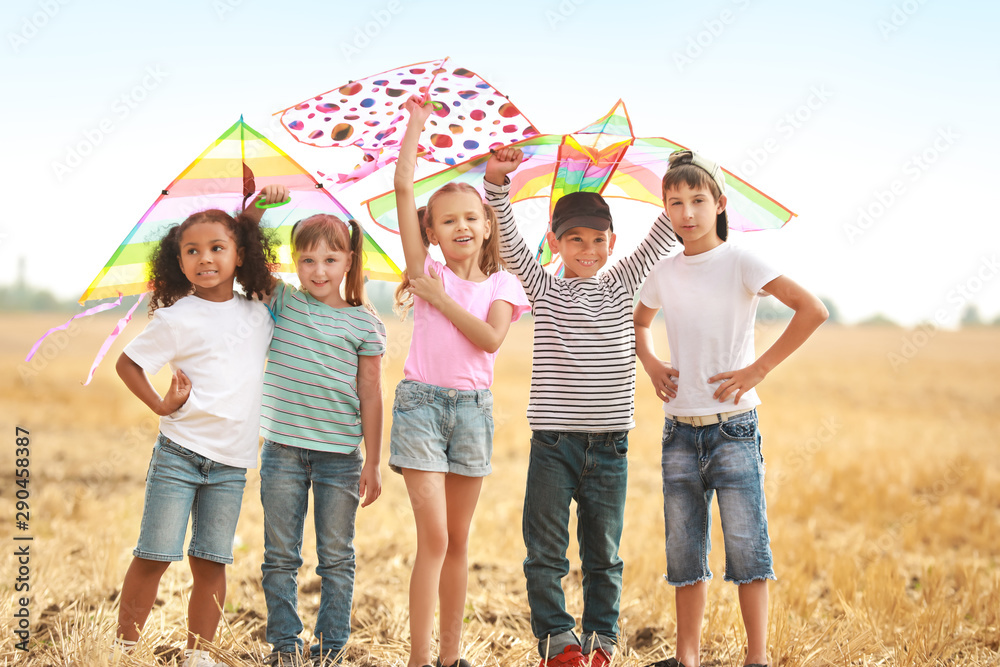 Little children flying kites outdoors