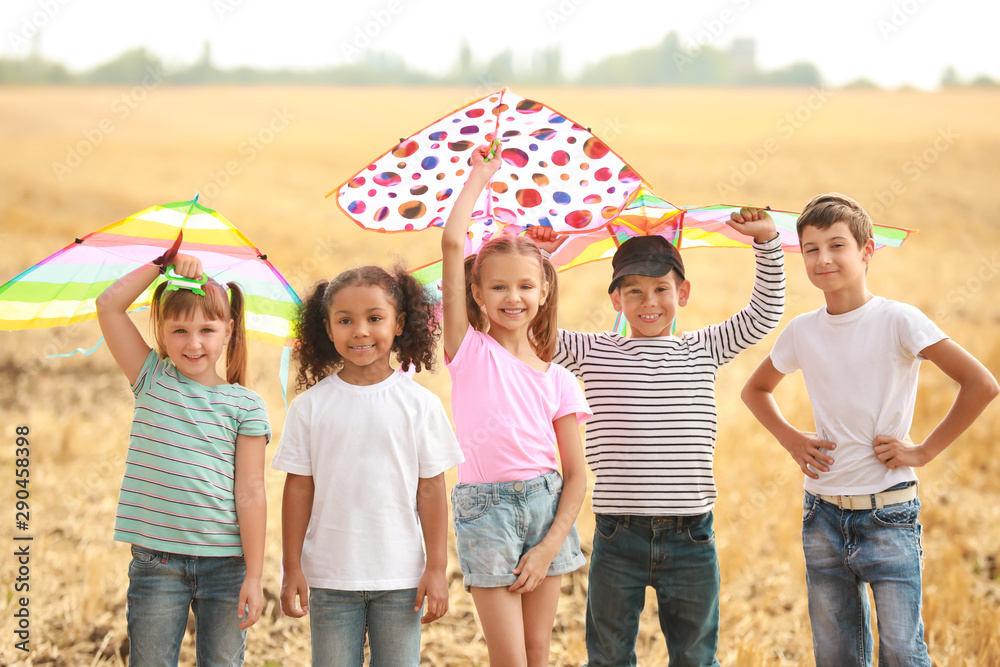 Little children flying kites outdoors