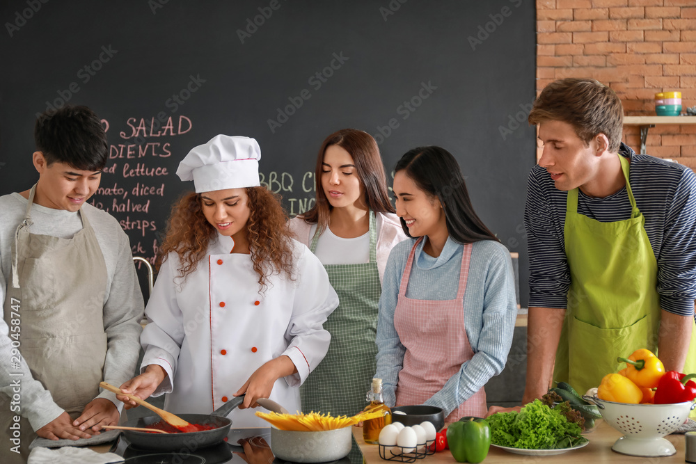 African-American chef and group of young people during cooking classes