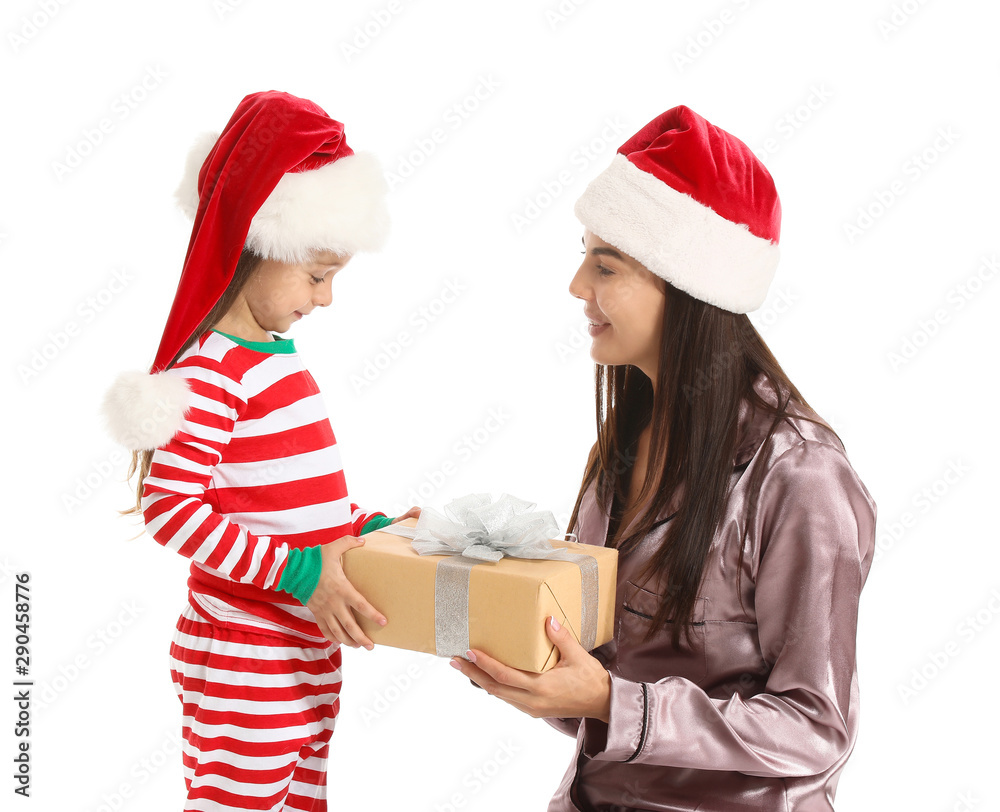 Woman and her little daughter with Christmas gift on white background