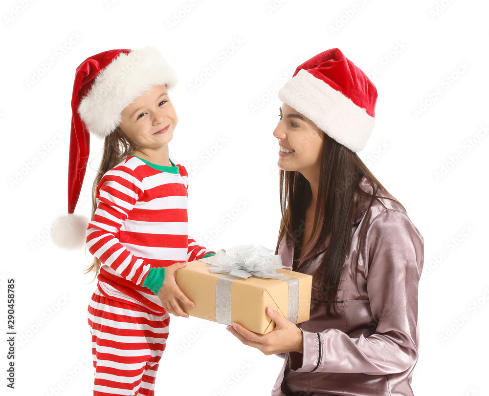 Woman and her little daughter with Christmas gift on white background