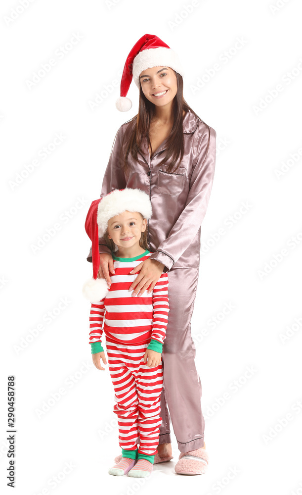 Woman and her little daughter in Santa hats on white background