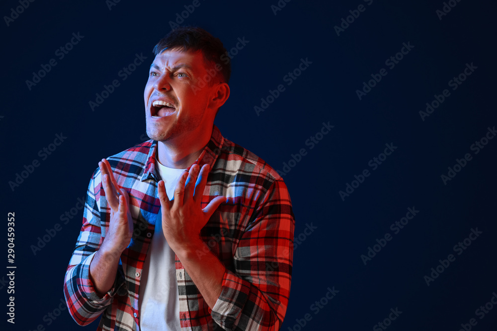 Portrait of angry man on dark background