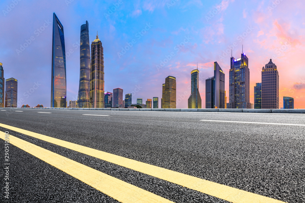 Shanghai modern commercial buildings and asphalt highway at sunset,China.