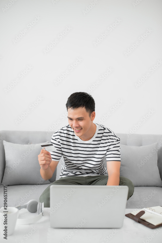 Smiling man during online shopping at home