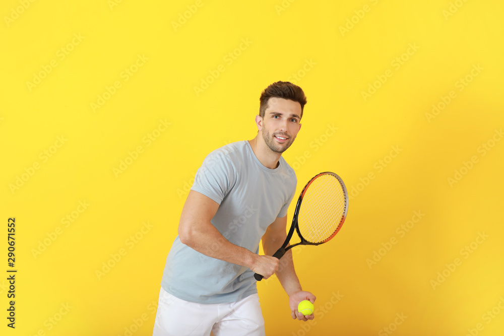 Handsome tennis player on color background