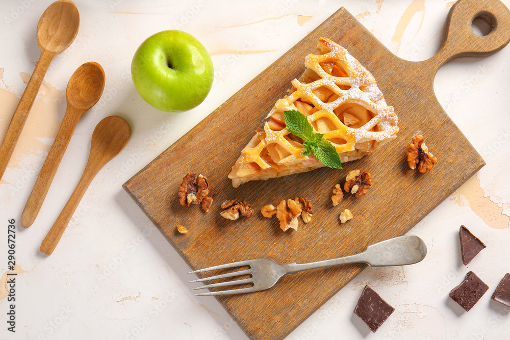 Slice of tasty apple pie on table