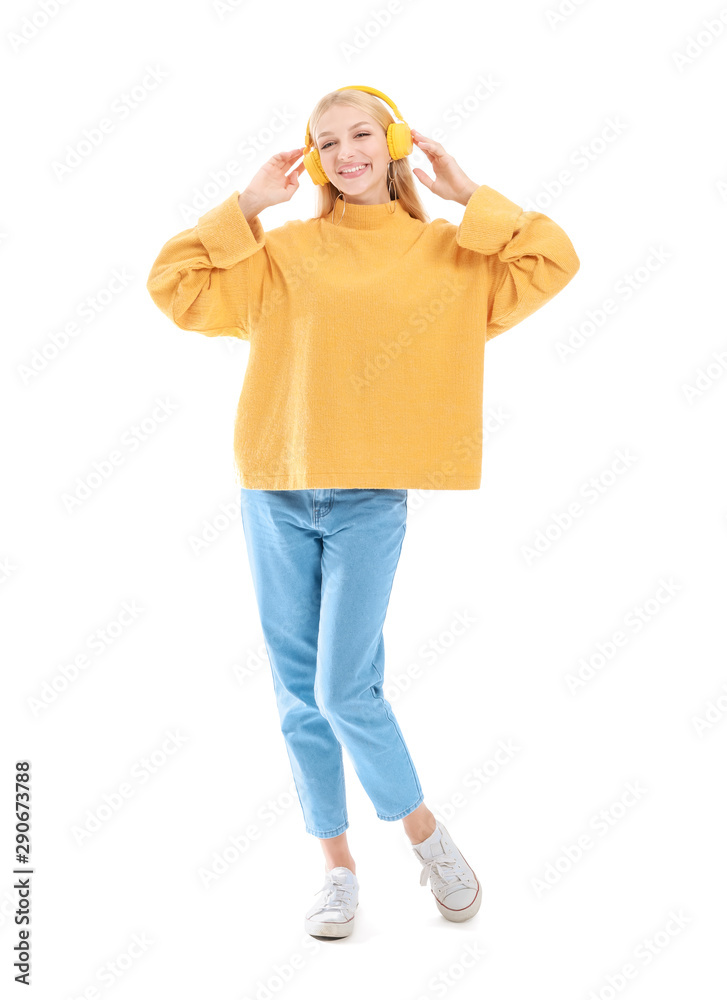 Beautiful young woman listening to music on white background