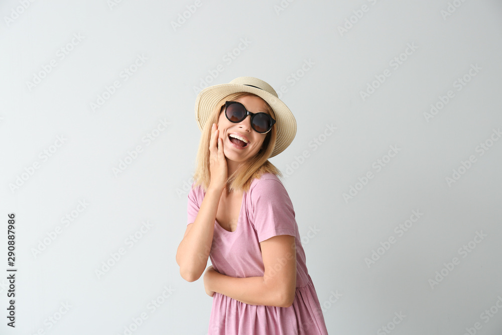 Stylish beautiful woman on light background