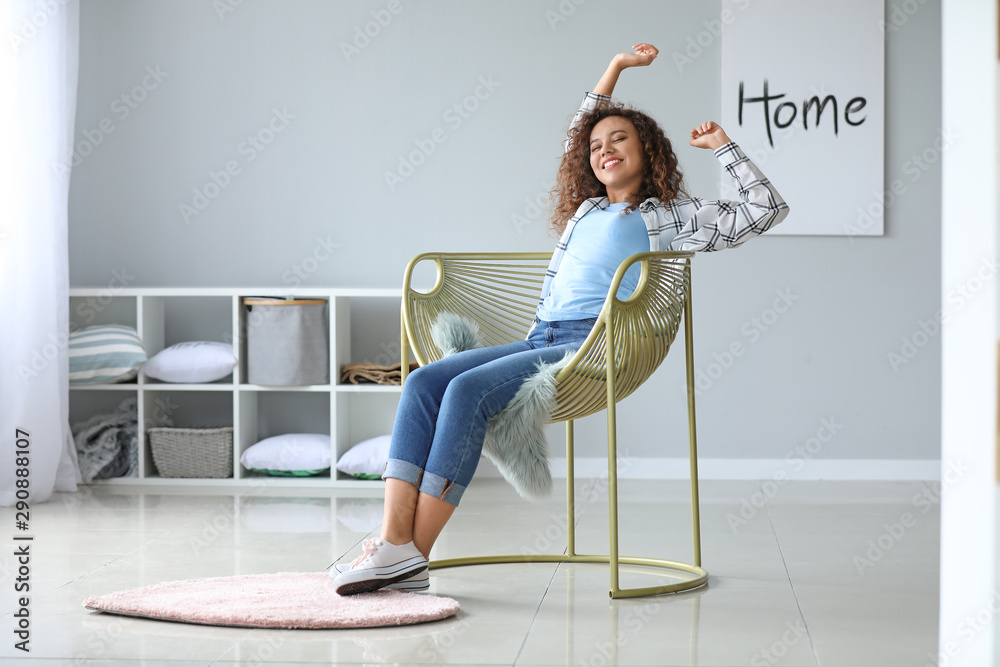 Beautiful African-American woman relaxing at home