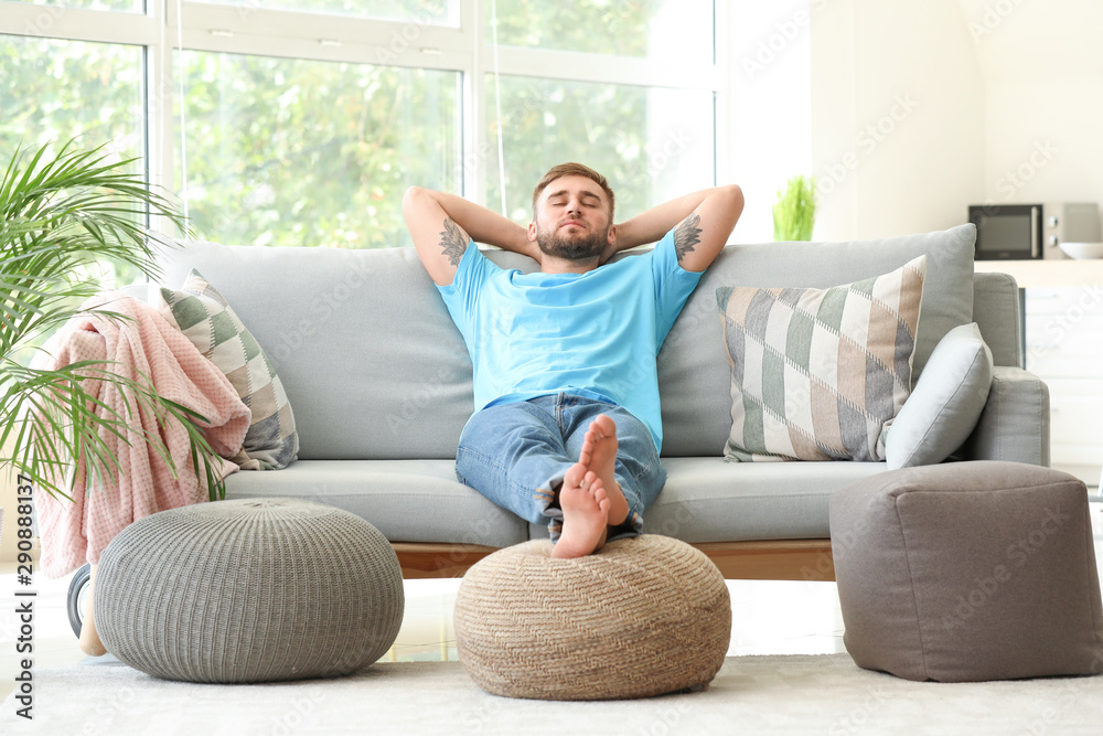 Handsome young man relaxing at home