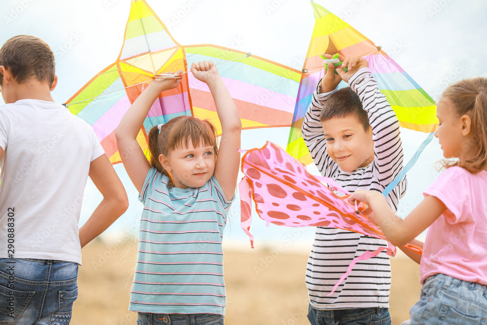 Little children flying kites outdoors