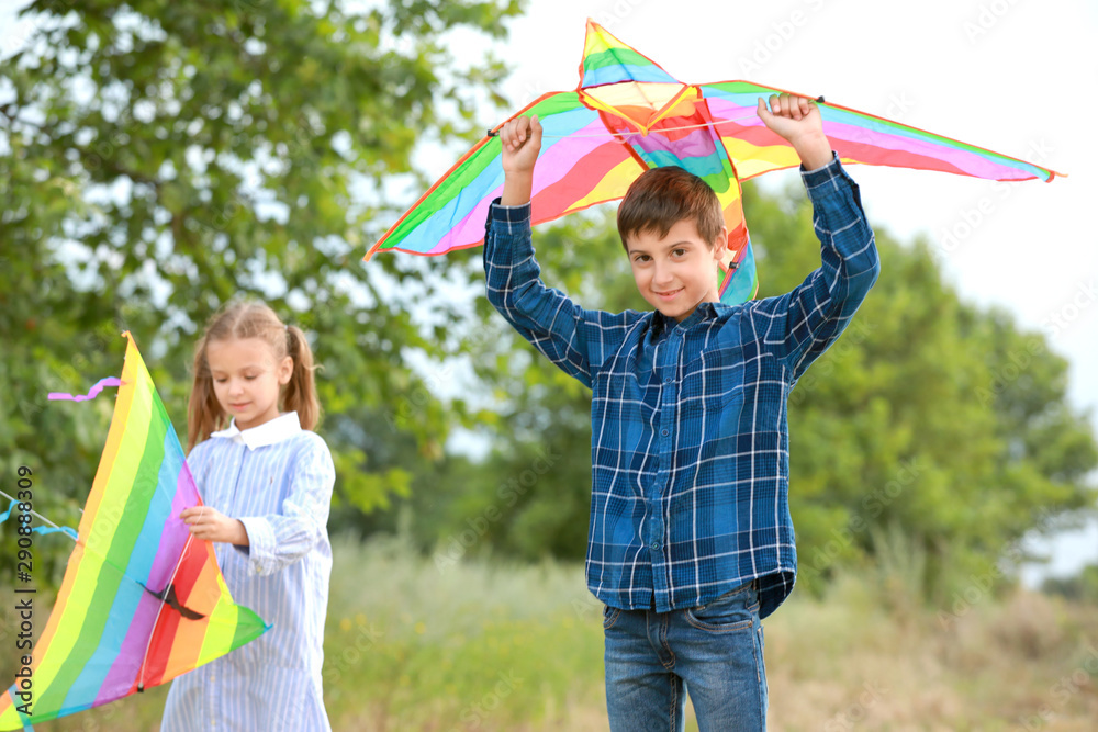 Little children flying kites outdoors