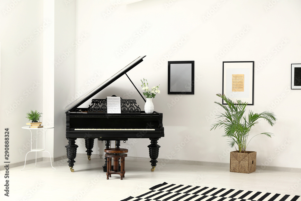 Black grand piano in interior of room