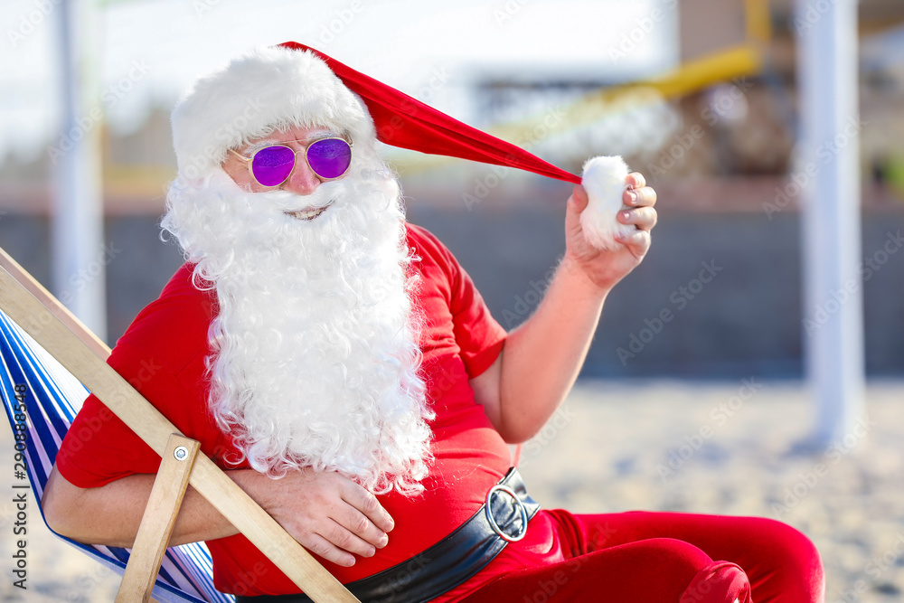 Happy Santa Claus resting at sea resort