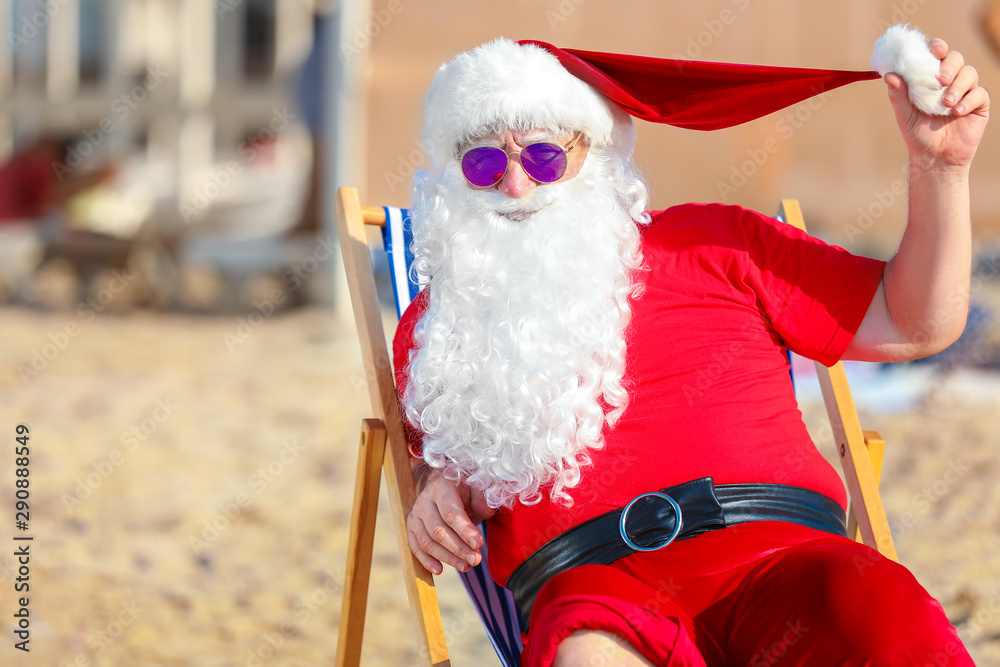 Happy Santa Claus resting at sea resort