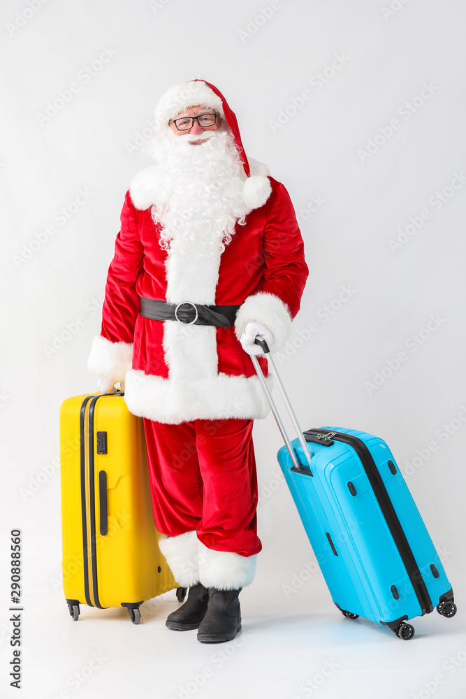 Santa Claus with luggage on white background