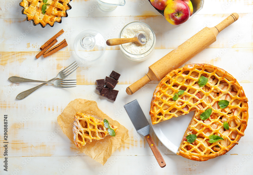 Composition with tasty apple pie on light table