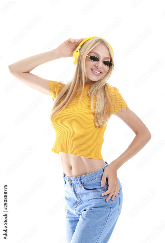 Beautiful young woman listening to music on white background