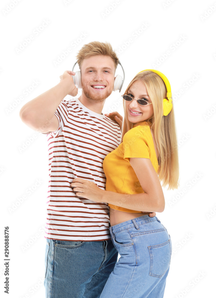 Young couple listening to music on white background