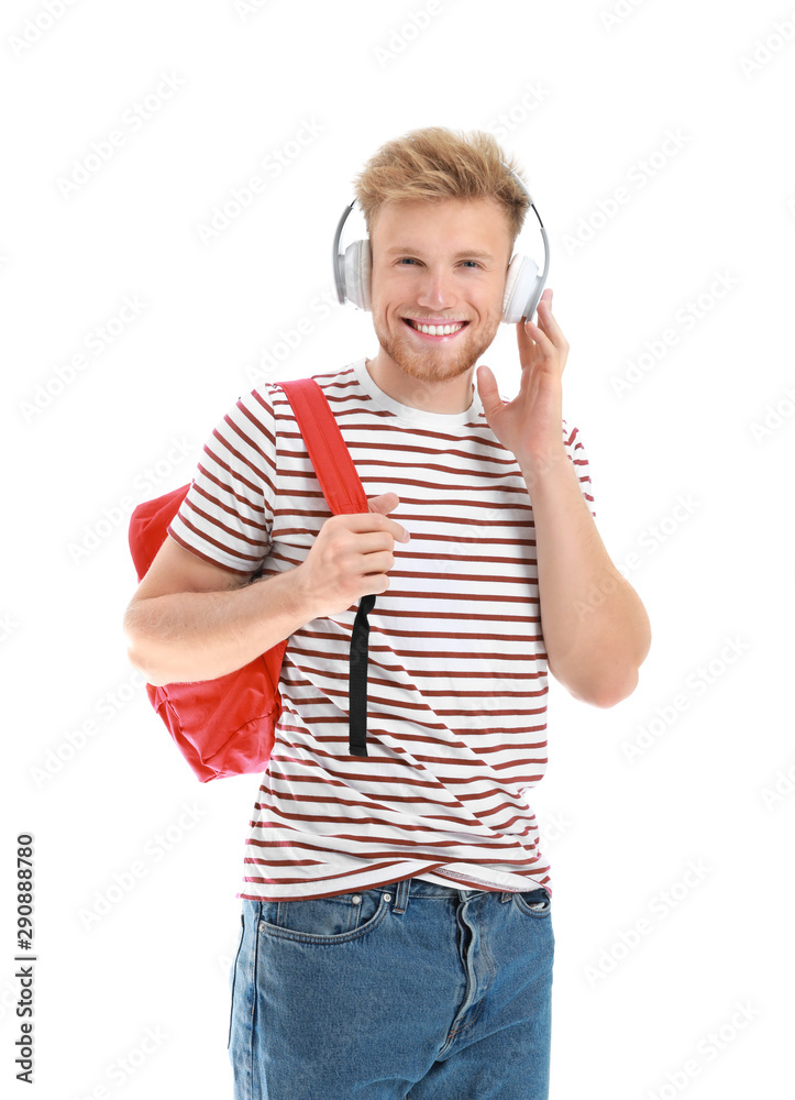 Handsome young man listening to music on white background