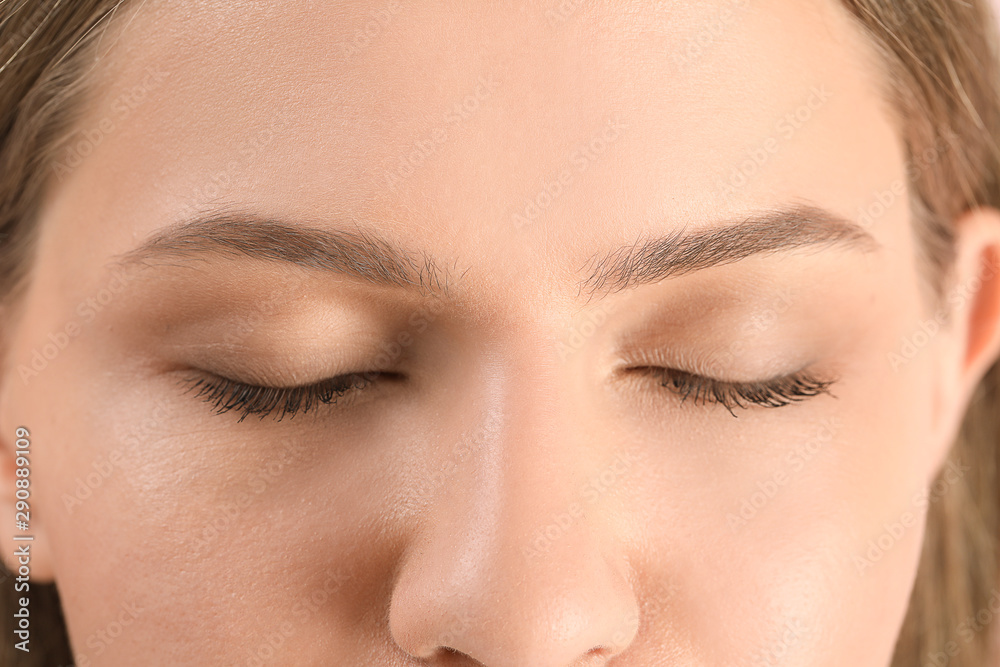 Young woman with beautiful eyebrows, closeup