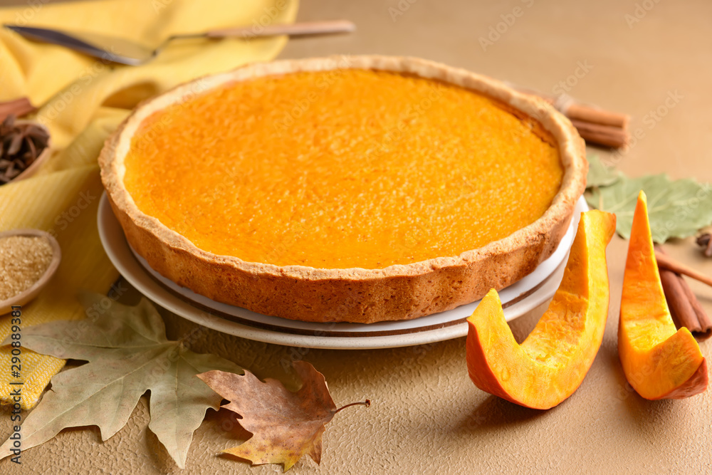 Tasty pumpkin pie on color background