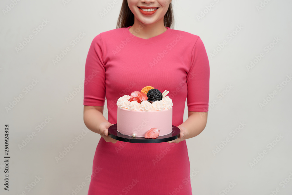 Woman holds birthday cake in her hands