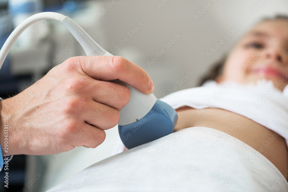 Medical exam little girl by ultrasound equipment