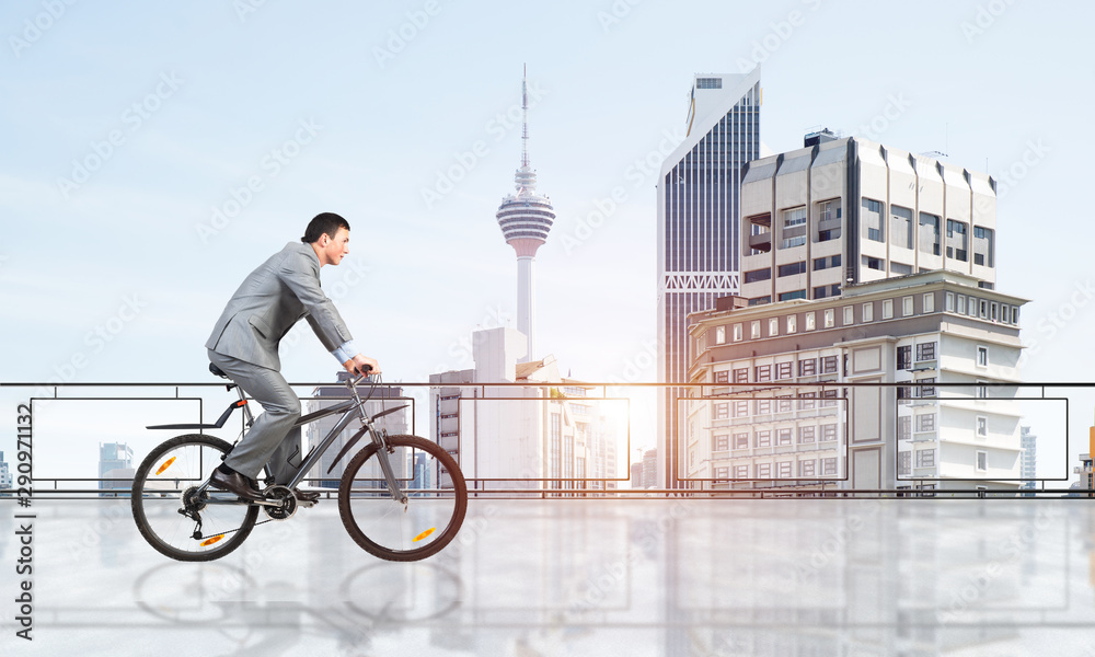 Man riding bicycle on penthouse balcony