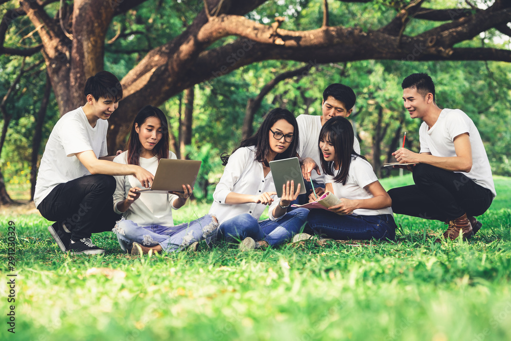 在大学或学校公园的小组项目中学习的年轻学生团队。快乐学习