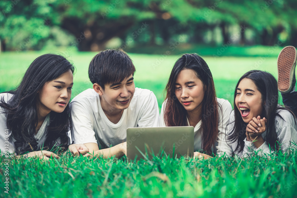 在大学或学校公园的小组项目中学习的年轻学生团队。学习快乐